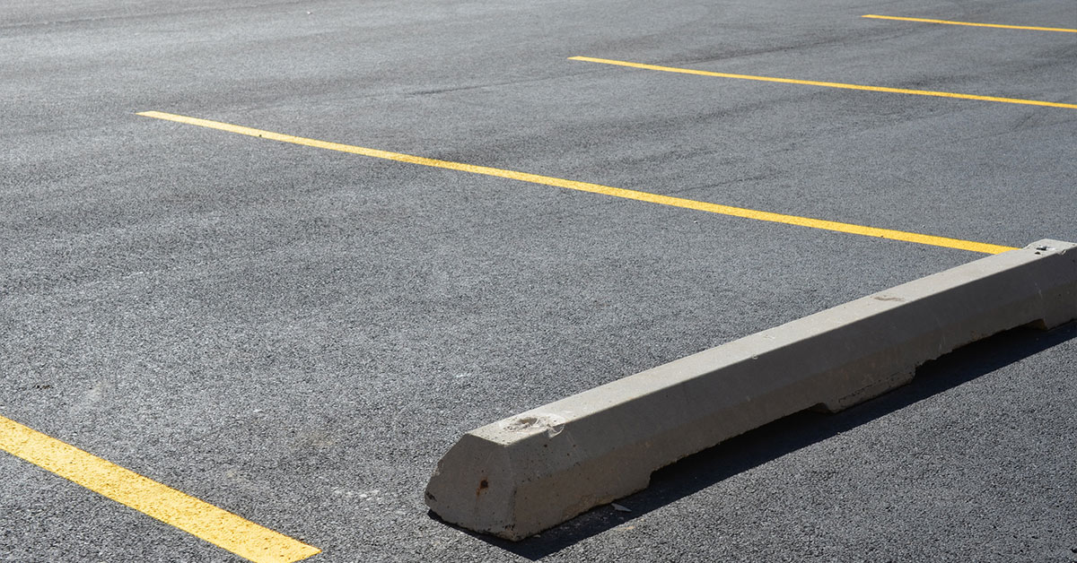wright-construction-Concrete-Vs-Rubber-Parking-Lot-Wheel-Stops