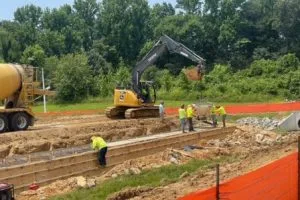Excavator and concrete truck supporting culvert construction at ABB Electrification project site