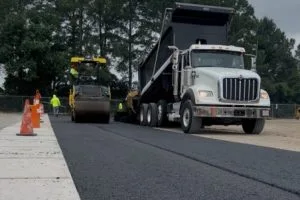Asphalt paving crew installing new pavement at Kohler facility in Huntsville, Alabama