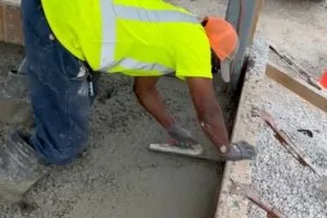 Concrete finishing work during commercial paving project at Kohler facility