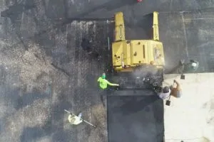 Asphalt paving crew installing fresh pavement during Orlando Health parking lot improvements